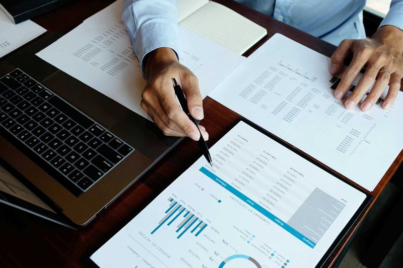 Laptop und Unterlagen bei der laufenden Finanzbuchhaltung